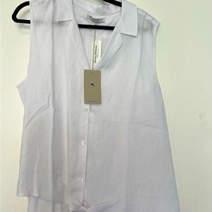 Sleeveless white cotton blouse.